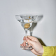 Woman holding martini glass during party with flash - PhotoDune Item for Sale