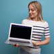 concentrated girl student showing laptop screen with mockup on blue background - PhotoDune Item for Sale