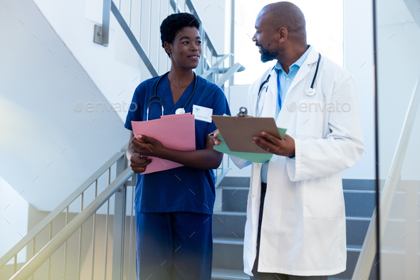 Happy African American Female And Male Doctor Talking On Hospital ...