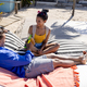 High angle view of caucasian young couple toasting beer while resting on loungers at tourist resort - PhotoDune Item for Sale