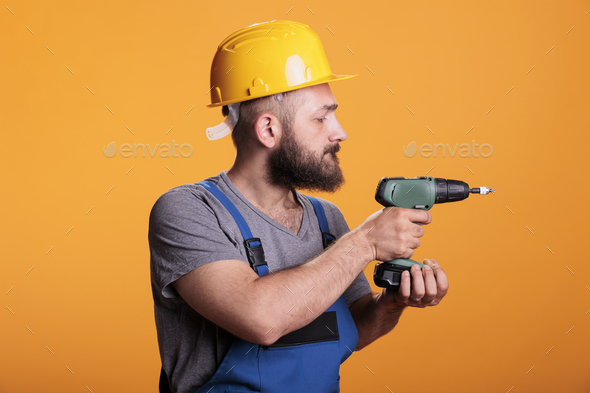 Professional craftsman working wtih electric power drill - Stock Photo - Images