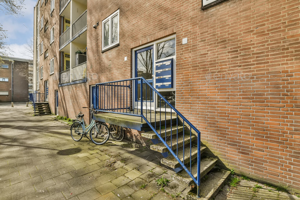 a brick building with stairs and a bike parked outside