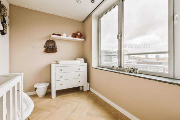 a bathroom with a large window and a dresser