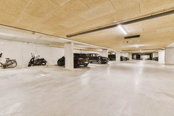a parking garage filled with cars and motorcycles