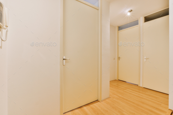 a room with three doors and a wood floor