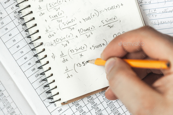 Math formulas are written in pencil in a notebook holding man in