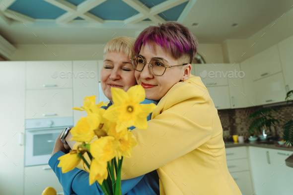 Daughter's Warm Embrace and Floral Tribute on Mother's Day, Women's Day