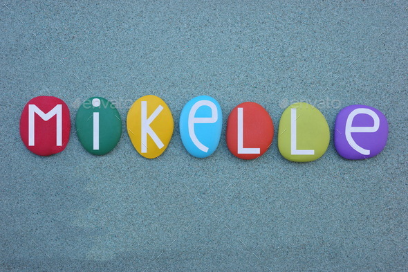 Mikelle, feminine name of Hebrew origin composed with multi colored stone  letters over green sand Stock Photo by ciaobucarest1