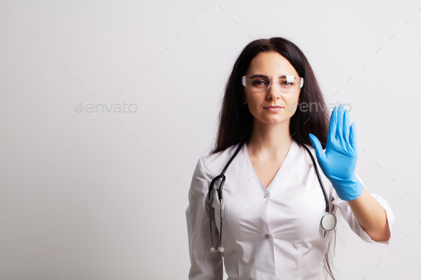 Doctor showing hand stop gesture, health safety concept