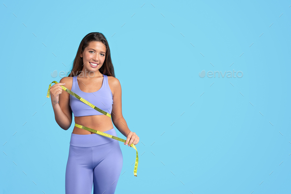 Premium Photo  With measuring tape young woman in yoga clothes is