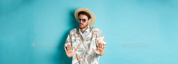 Alarmed tourist asking to stay away, step back from something cringe, showing rejection gesture