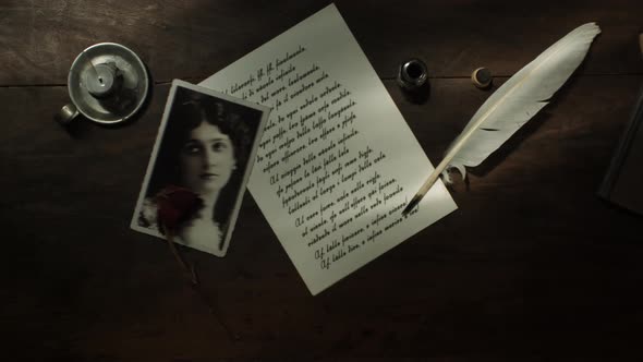 Handwritten letter with quill and extinguished candle