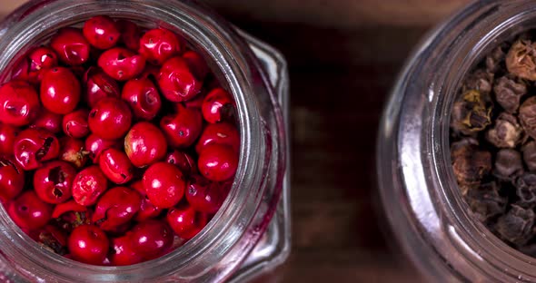 Glass jars with black and red peppercorns alt
