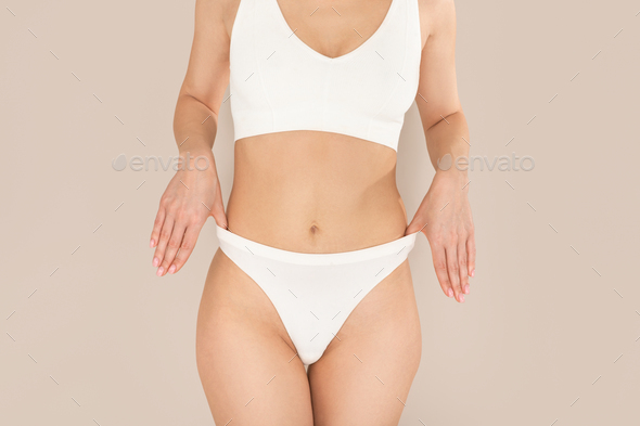 Unrecognizable well fit young woman posing in white underwear Stock Photo  by Prostock-studio