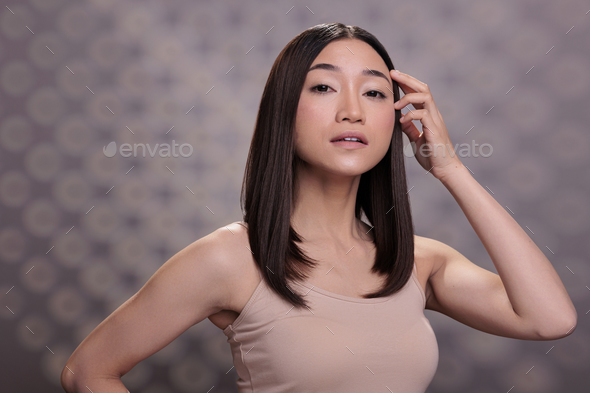 590px x 393px - Asian fashion model posing with arm on face Stock Photo by DC_Studio