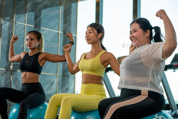 Humor in sports Ball Yoga. Fat Asian woman with her Yoga Instrutor teacher training