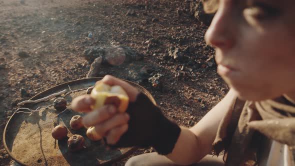 Woman in Eating Rotten Apples in Dystopian World alt