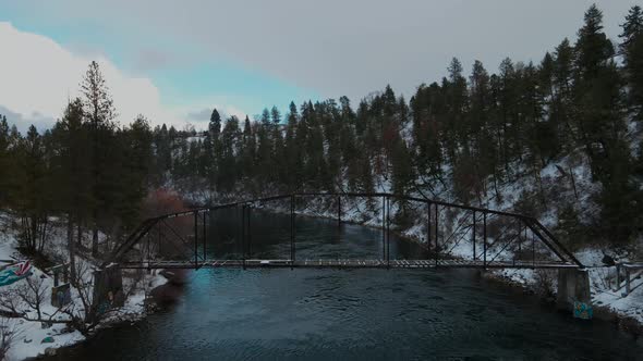 Snowy river in spokane Washington, spokane river during winter over abandoned railway bridge right b alt