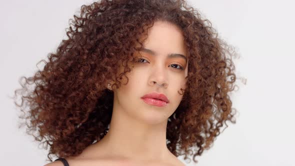 Mixed Race Black Woman with Freckles and Curly Hair Closeup Portrait with  Hair Blowing by RudoVideoStudio