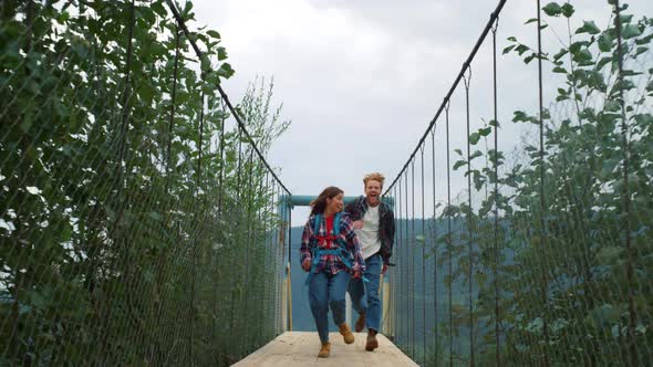 Fun Couple Running Nature on Mountains River Bridge alt