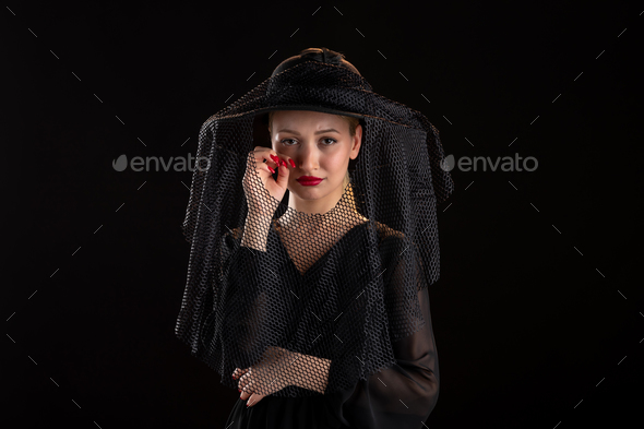 mourning woman dressed in black for funeral on the black isolated background death grim reaper
