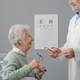 Senior woman having an eye test and trying new glasses - PhotoDune Item for Sale