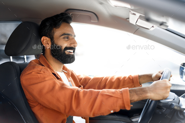 Proud Indian Driver Guy Driving Luxury Automobile, Posing In Vehicle