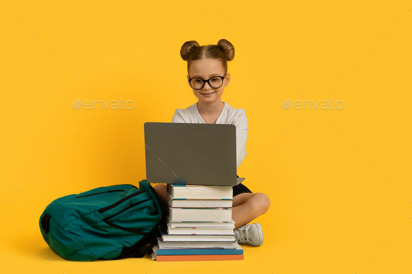 Online Learning. Little Girl Doing Homework On Laptop, Sitting At Book ...