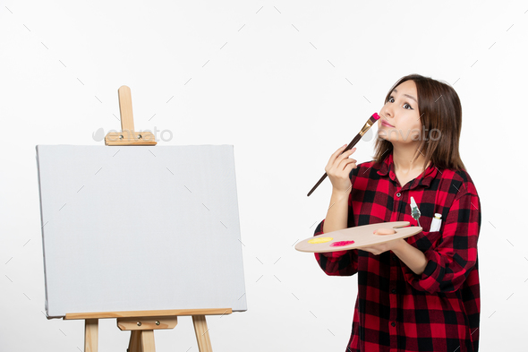 front view young female preparing to draw on easel on white background exhibition painting brush