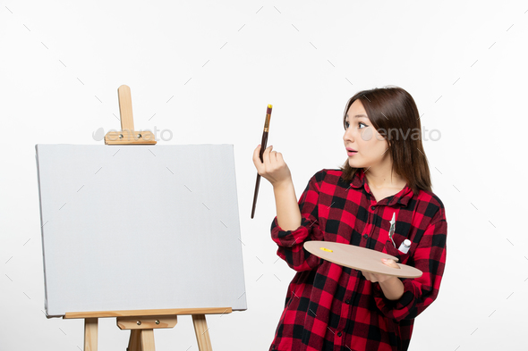 front view young female preparing to paint on easel on white background art exhibition painting