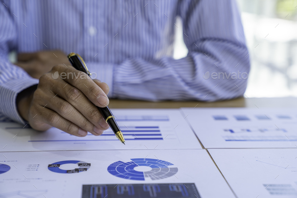 Businessman sitting at a desk financial data analysis and market growth report graph and investment