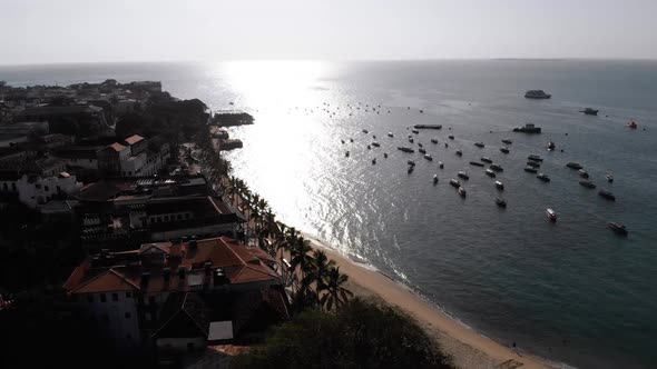 Aerial Waterfront and Seaport of Stone Town Anchored Boats in Ocean Zanzibar alt