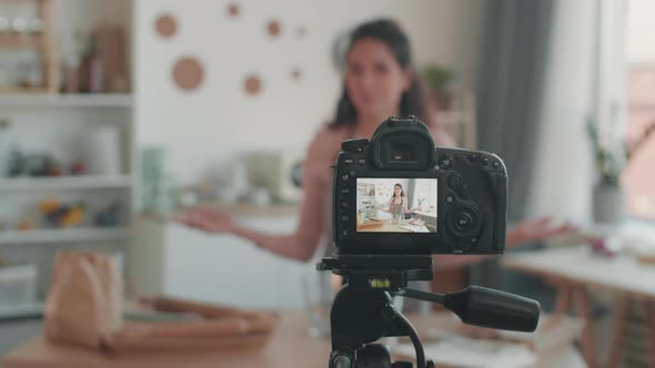 Woman Filming Cooking Vlog in Kitchen alt
