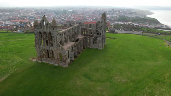 Whitby Abbey ruins and surrounding landscape, North Yorkshire in England. Aerial circling alt