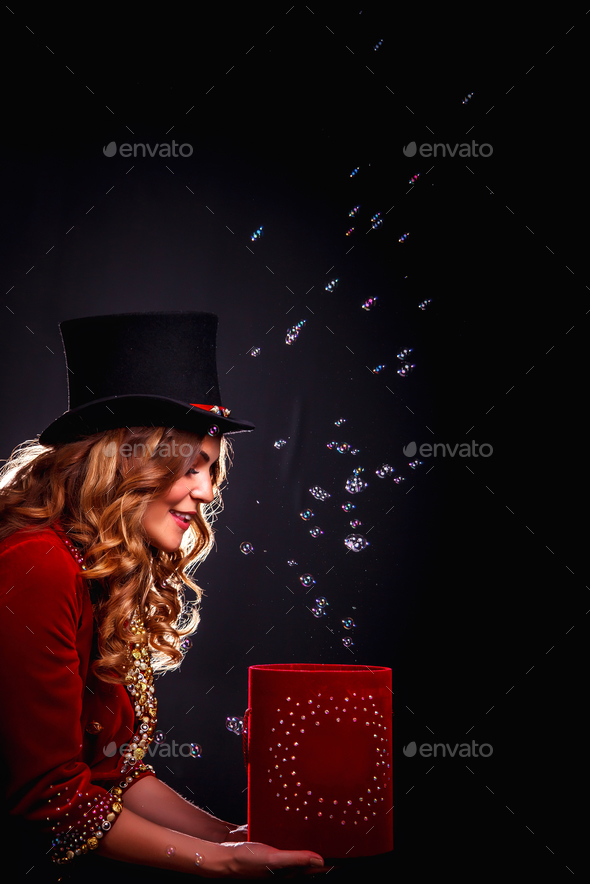 Magician woman with box soap bubbles show, an illusionist in theatrical clothes