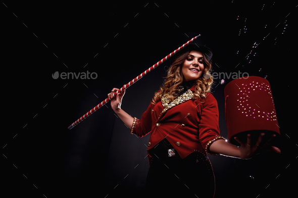 Magician woman with cane and box soap bubbles show, an illusionist
