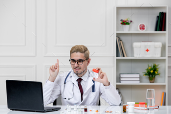 (medical)cute smart handsome doctor guy in lab coat in hospital with stethoscope smiling