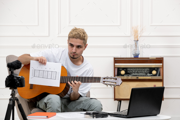 elearning remotely giving guitar classes at home handsome cute young guy recording vlog