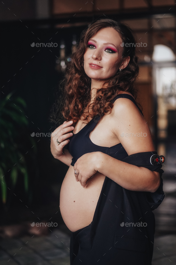 Pregnant woman with a big belly feeling happy.Woman pregnancy concept Stock  Photo by elmizaismagilova