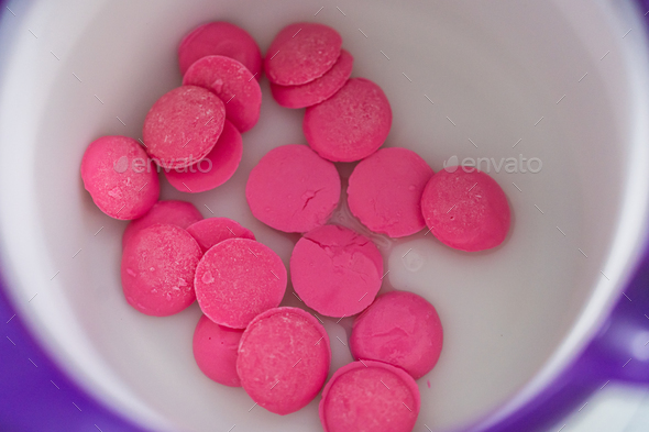 Mini pink chocolates Stock Photo by arina-habich