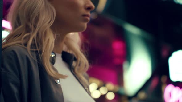 Attractive Girl in Night Club Looking Thoughtfully in Neon Lights City alt