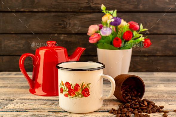 a front view empty cup with red kettle brown coffee seeds and flowers on the wooden desk and dark