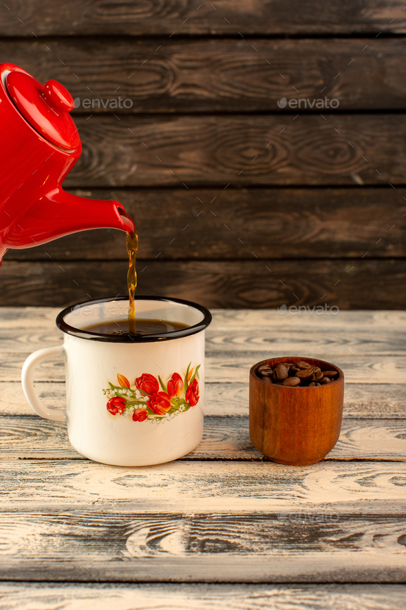 Tea kettle with boiling water on a black background, Stock image