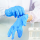 Scientist hands putting in nitrile blue latex gloves in labcoat wearing nitrile gloves - PhotoDune Item for Sale
