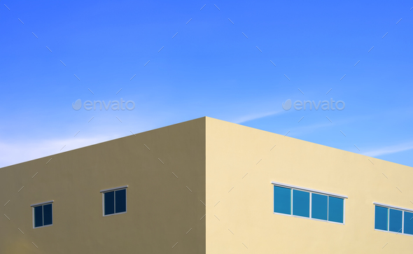 Symmetric view of yellow modern building with glass windows