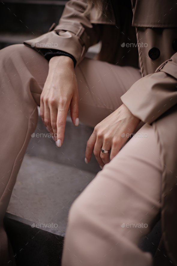 Close up stylish woman wearing business beige suit and minimalist accessory