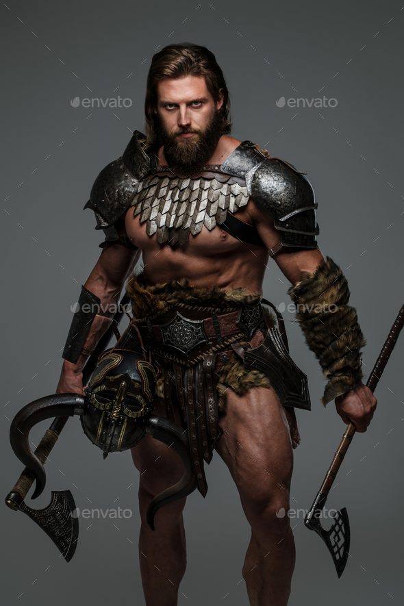 Bearded viking with long hair holding a two axes