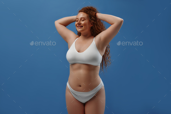 Redhead girl with freckles on a blue background