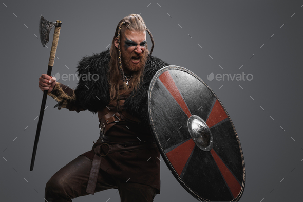 Attacking viking barbarian with rounded shield and axe Stock Photo by ...