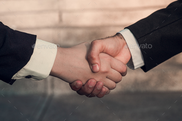 Done deal between two business people sealed with a handshake
